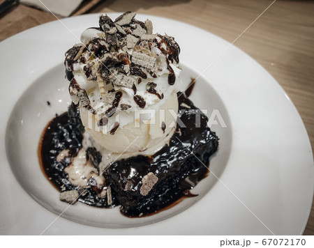 Chocolate brownies cake with whipped cream and ice crem on top Chocolate brownies cake with whipped cream and ice crem on top 67072170