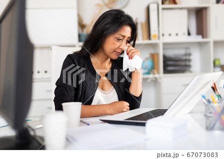 Upset business woman crying at workplace in office Upset business woman crying at workplace in office 67073083