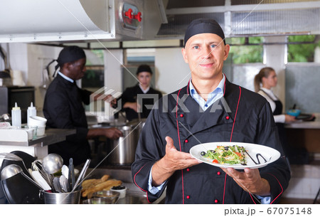 Chef with cooked dish 67075148