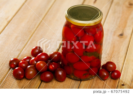 Marinated tomatoes in jar, with ingredients 67075492