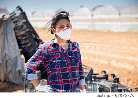 Hispanic female farmer in medical face mask Hispanic female farmer in medical face mask 67075770