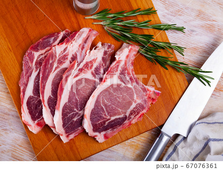 Close up of raw pork's chops on wooden table Close up of raw pork's chops on wooden table 67076361