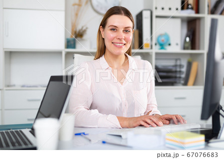 Young woman working at office alone Young woman working at office alone 67076683