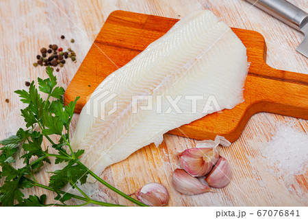 Raw halibut fillet on wooden table Raw halibut fillet on wooden table 67076841
