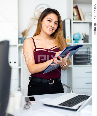 Woman writing down tasks Woman writing down tasks 67077109