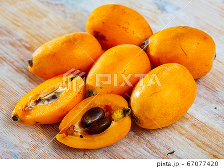 Ripe medlar fruits nispero on wooden surface 67077420