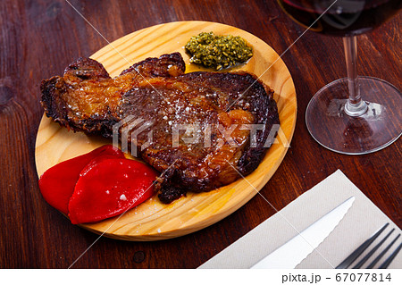 Fried veal entrecote with pesto and peppers Fried veal entrecote with pesto and peppers 67077814