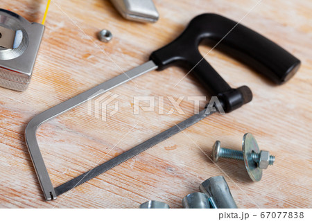 Top view of hacksaw surrounded by various tools Top view of hacksaw surrounded by various tools 67077838