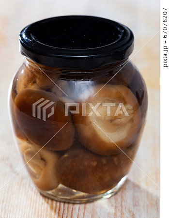 Closed glass jar with natural shiitake 67078207