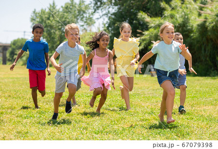 Cheerful kids are jogging together in the park 67079398
