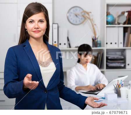 Portrait of successful confident business woman in office interior Portrait of successful confident business woman in office interior 67079671