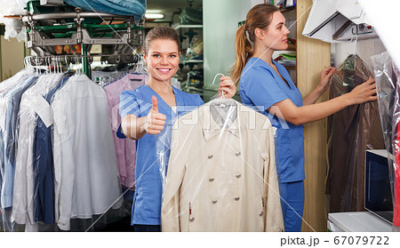 Two workers showing clean clothing Two workers showing clean clothing 67079722