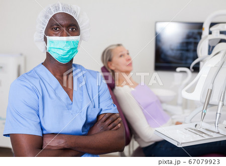 Doctor dentist shows patient an x-ray Doctor dentist shows patient an x-ray 67079923