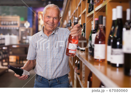 Glad man visiting winehouse in search of wine 67080060