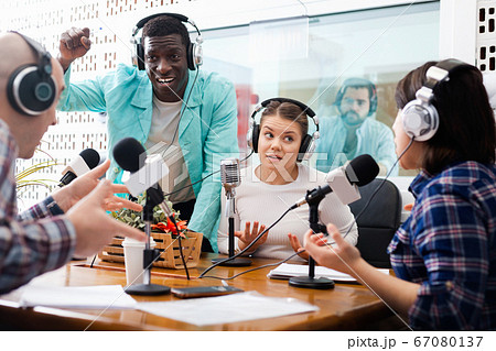 Scandal interview. Two outraged guests answering provocative questions of radio hosts during live radio show 67080137