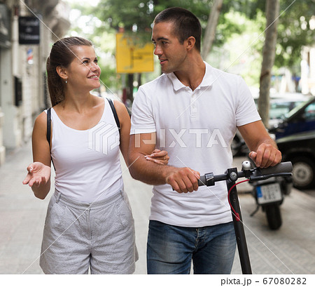 Couple enjoying electro scooter riding 67080282