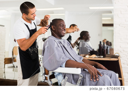 African male client getting haircut African male client getting haircut 67080673