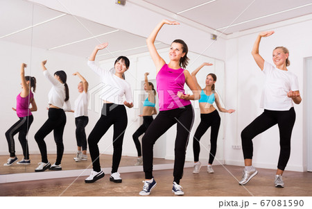 Cheerful different ages women learning swing steps at dance class Cheerful different ages women learning swing steps at dance class 67081590