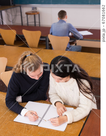 Two student girls studying in classroom Two student girls studying in classroom 67081662