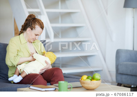 Mother feeding her baby Mother feeding her baby 67086117