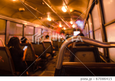 Blurry Light Inside Bus of the Night in Blurry Background. Blurry Light Inside Bus of the Night in Blurry Background. 67086415
