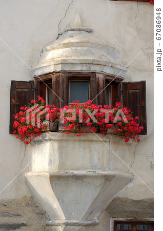 Ancient balcony with wooden windows - Guarda village Engadine Switzerland 67086948