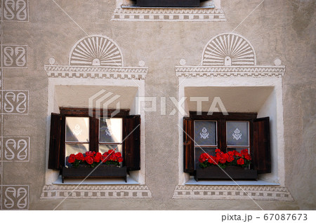 Ancient wooden windows with decorations - Guarda village Engadine Switzerland 67087673