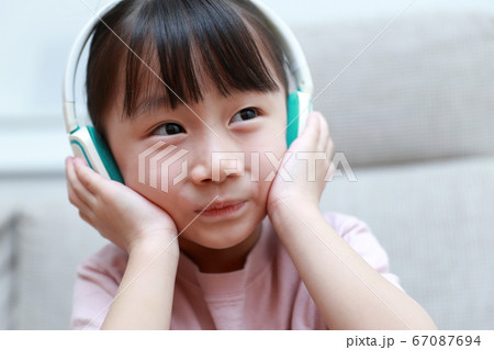 ヘッドフォンで音楽を聴きながら歌う女の子の写真素材