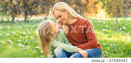 Young mother and little daughter hugging each 67089482