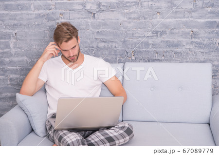 handsome man online dating. relaxed male on sofa. handsome man online dating. relaxed male on sofa. 67089779
