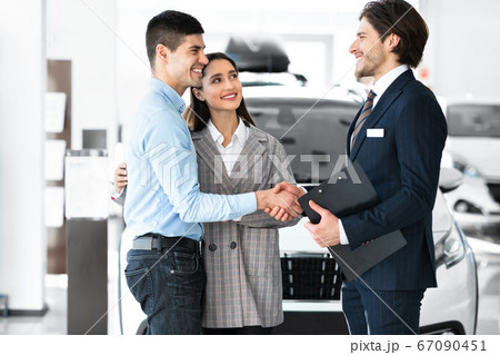 Handsome Manager Shaking Hands With Young Buyers Handsome Manager Shaking Hands With Young Buyers 67090451