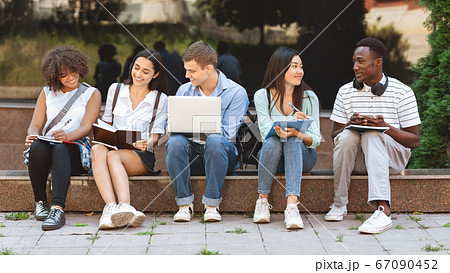 Exam Study. Group Of Interracial Students Preparing For Lectures Together Outdoors Exam Study. Group Of Interracial Students Preparing For Lectures Together Outdoors 67090452