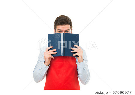 What to cook. Man hipster cook apron reading book 67090977