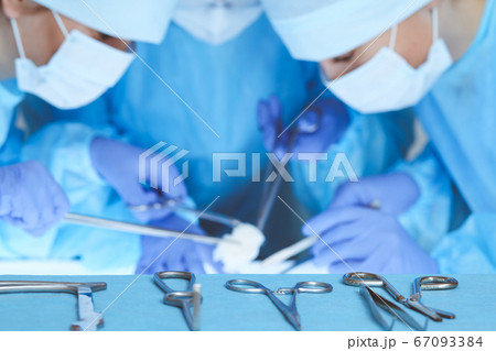 Close-up of medical team performing operation. Group of surgeons at work are busy of patient. Medicine, veterinary or healthcare and emergency in hospital Close-up of medical team performing operation. Group of surgeons at work are busy of patient. Medicine, veterinary or healthcare and emergency in hospital 67093384