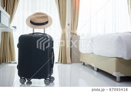 Black Luggage and hat in modern hotel room with 67093418