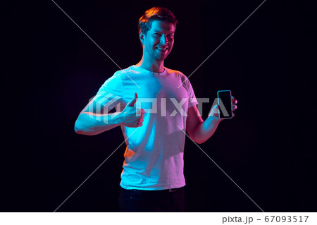Caucasian beautiful young man's portrait on black studio background, emotional and expressive. Copyspace for ad. Caucasian beautiful young man's portrait on black studio background, emotional and expressive. Copyspace for ad. 67093517