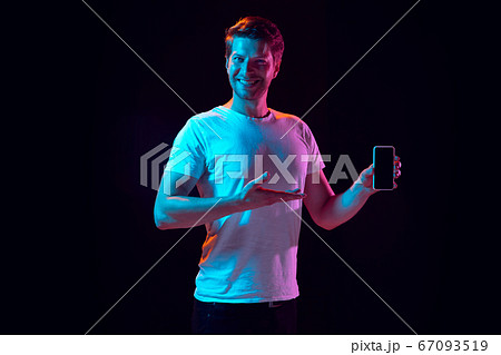 Caucasian beautiful young man's portrait on black studio background, emotional and expressive. Copyspace for ad. Caucasian beautiful young man's portrait on black studio background, emotional and expressive. Copyspace for ad. 67093519