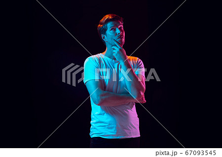 Caucasian beautiful young man's portrait on black studio background, emotional and expressive. Copyspace for ad. Caucasian beautiful young man's portrait on black studio background, emotional and expressive. Copyspace for ad. 67093545