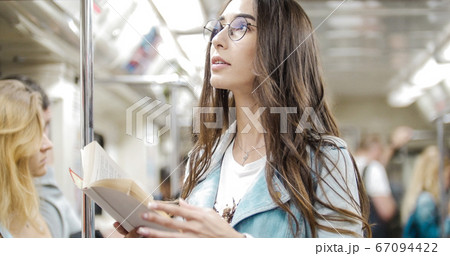 The girl goes to the subway and reads a book The girl goes to the subway and reads a book 67094422