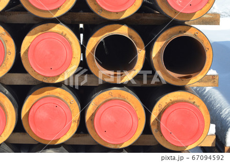 Construction Materials. Industrial pipes under snow. 67094592
