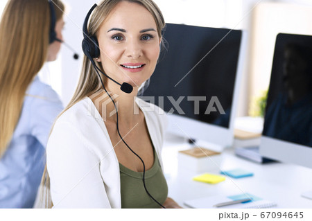 Portrait of call center operator at work. Group of people in a headset ready to help customers. Business concept Portrait of call center operator at work. Group of people in a headset ready to help customers. Business concept 67094645