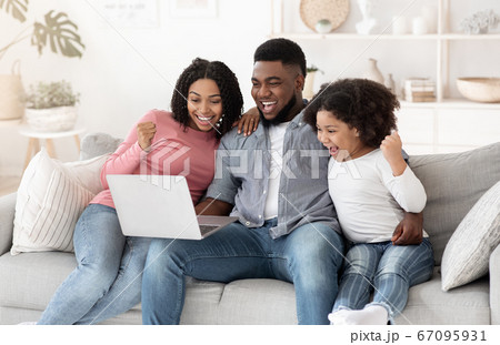 Online Lottery. Excited African American Family Of Three Celebrating Win With Laptop Online Lottery. Excited African American Family Of Three Celebrating Win With Laptop 67095931