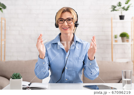 Work from home and video call. Woman with headset, gesticulation to camera 67096219