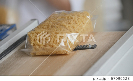 Food industry - conveyor with plastic pack of macaroni 67096528