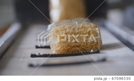 Food industry - conveyor with plastic pack of macaroni 67096530