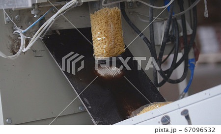 Food manufacturing - packing of macaroni in plastic bags 67096532