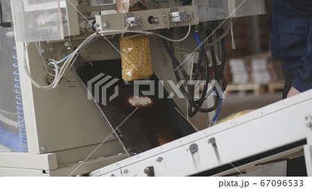 Food manufacturing - packing of macaroni in plastic bags 67096533