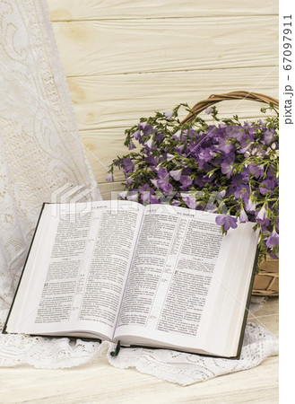 Open Bible and bouquet flax in wicker basket. Retro style, vintage Open Bible and bouquet flax in wicker basket. Retro style, vintage 67097911