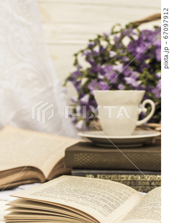 cup coffee (tea), books and bouquet flax in wicker basket. Retro style, vintage cup coffee (tea), books and bouquet flax in wicker basket. Retro style, vintage 67097912