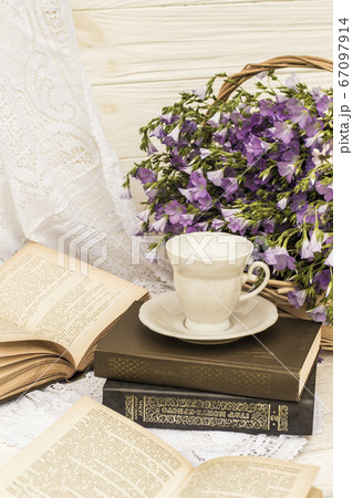 cup coffee (tea), books and bouquet flax in wicker basket. Retro style, vintage cup coffee (tea), books and bouquet flax in wicker basket. Retro style, vintage 67097914